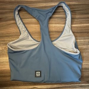 A blue razor back JOLYN sports bra